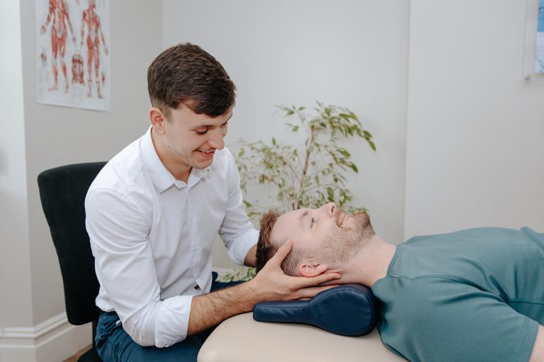 Physiotherapist massaging patient's head