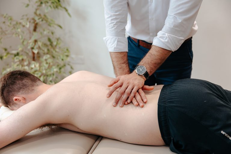 Patient receiving back massage treatment