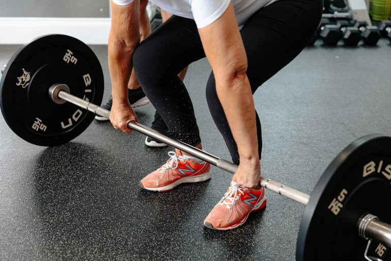 Runner lifting weights during Strength and Movement class