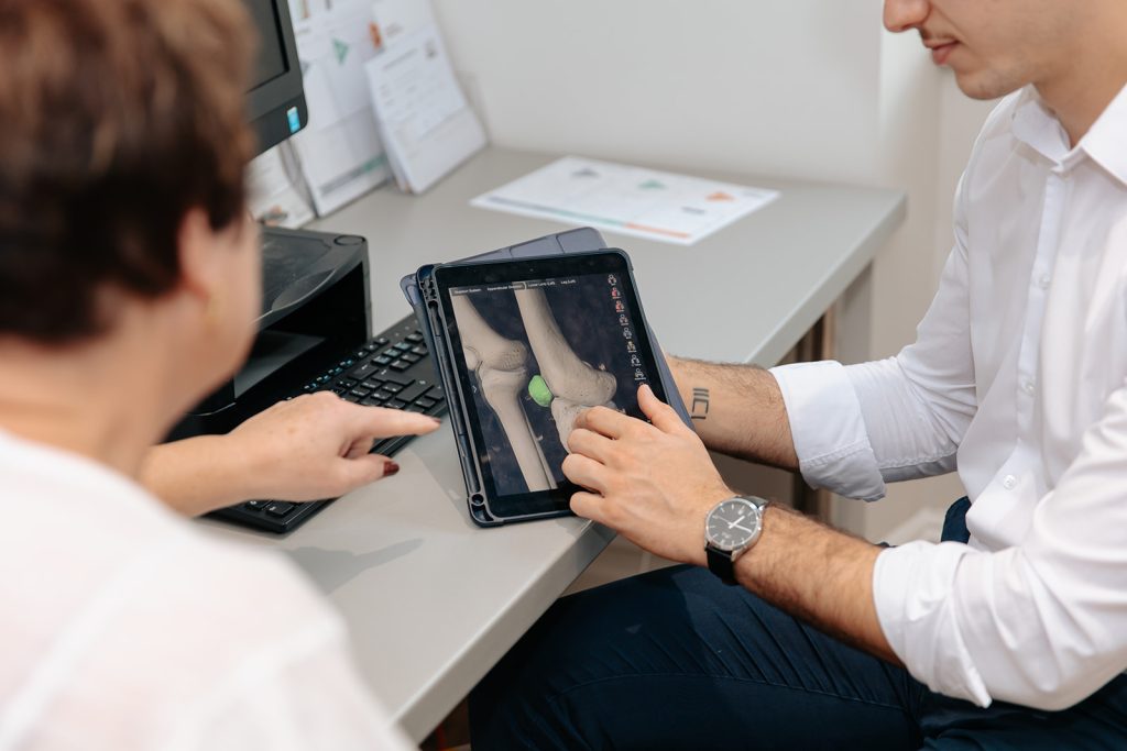 Physiotherapist showing scan to patient