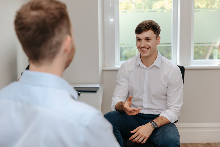 Physiotherapist discusses treatment with patient