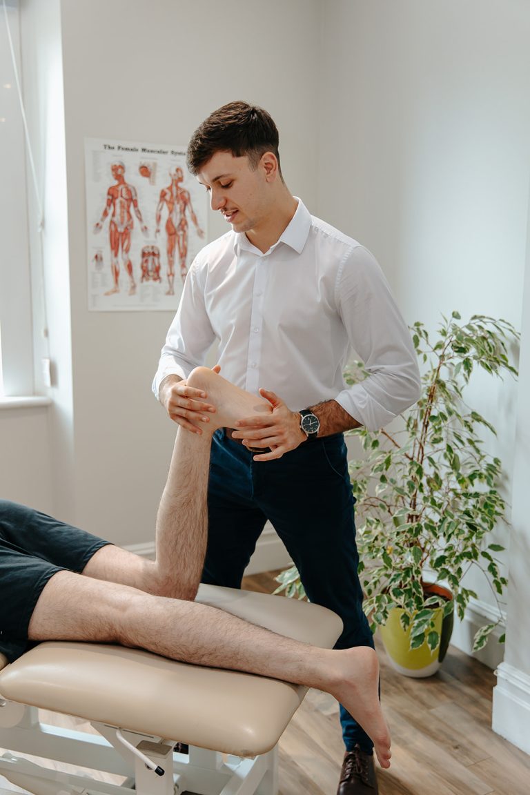 Physiotherapist stretches patients foot