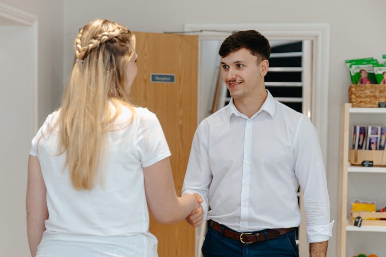 Physiotherapist shaking hands with patient