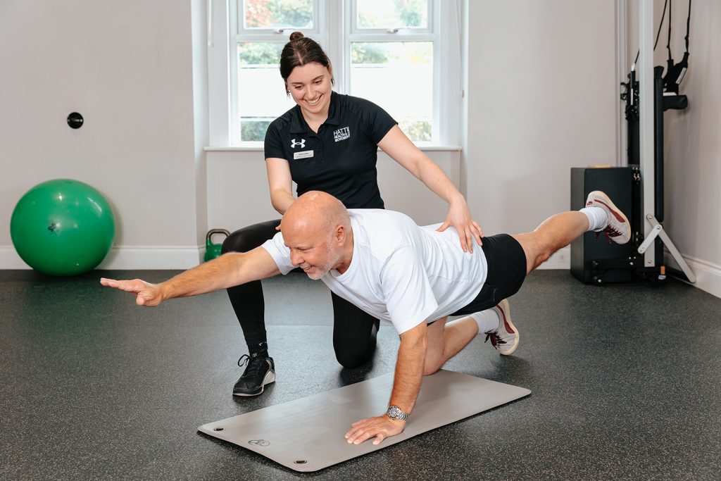 Rehab therapist helps patient stretch