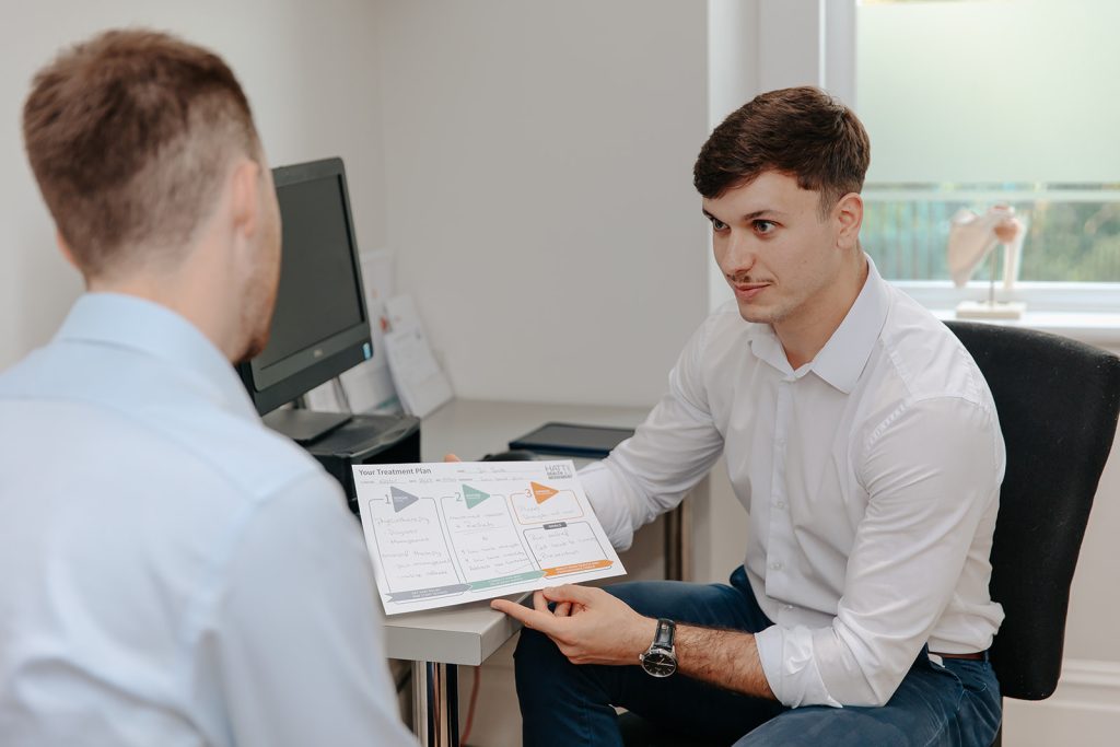 Physiotherapist explains treatment plan to patient