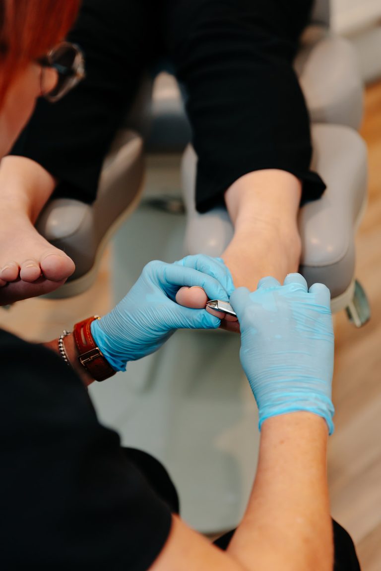 Podiatrist cutting toenail