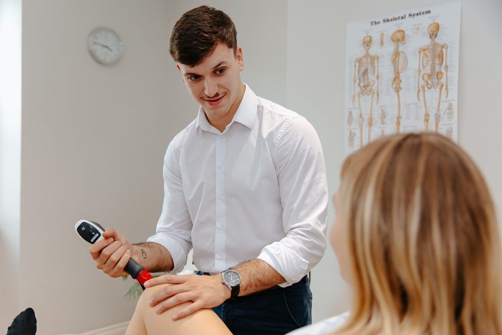 Therapist applying Shockwave therapy on patient