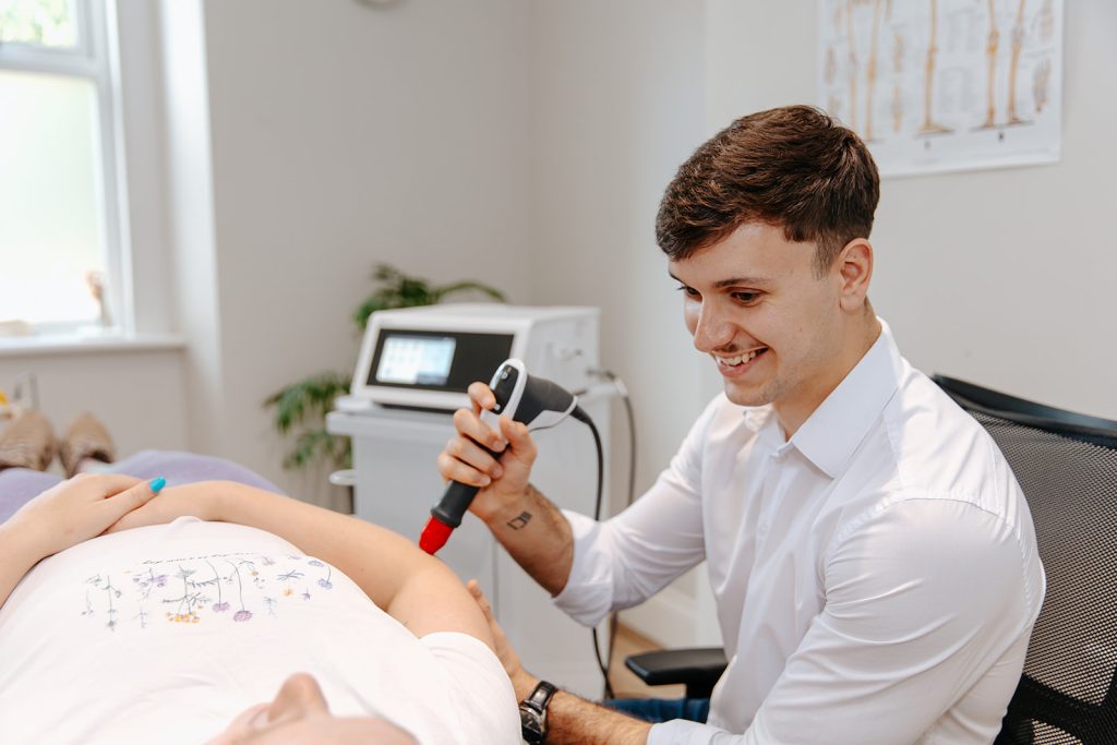 Therapist applying Shockwave therapy on patient